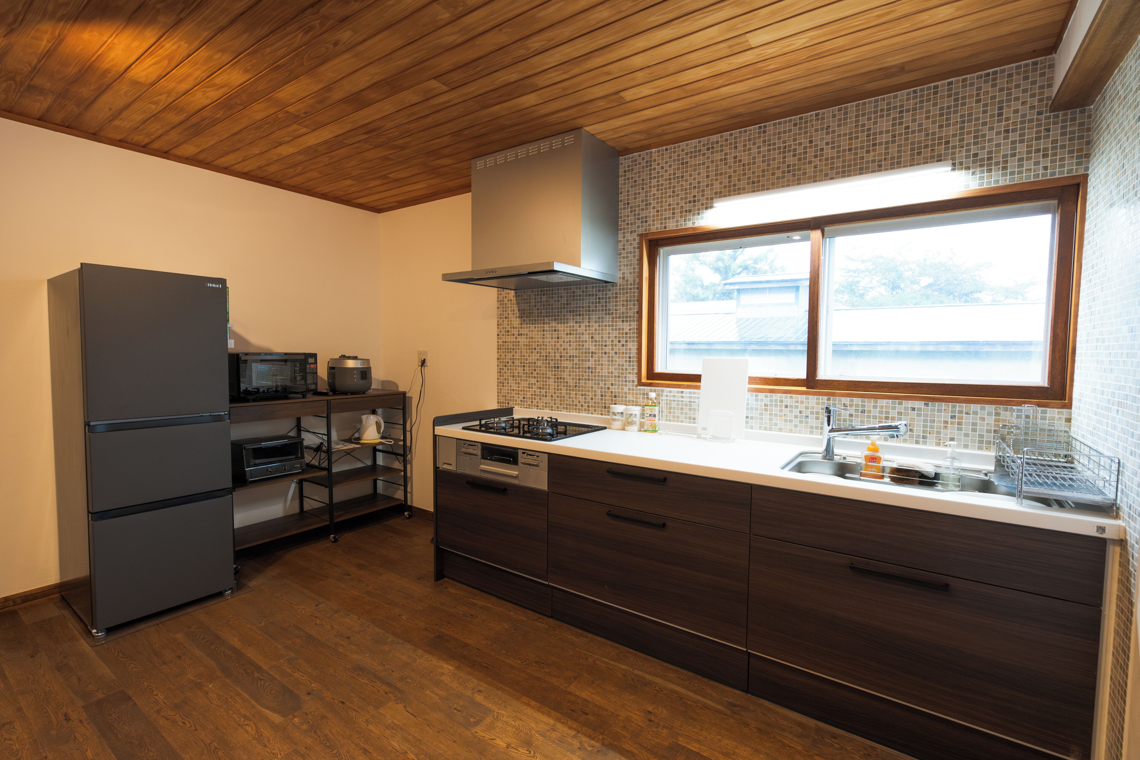 A modern kitchen with a built-in oven, microwave, and gas stove.