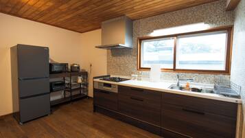 A modern kitchen with a built-in oven, microwave, and gas stove.