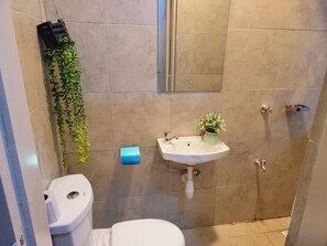 Ein Badezimmer mit Toilette, Waschbecken und Dusche.