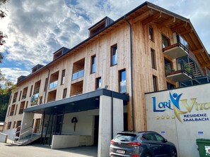 A multi-story wooden building with a modern design, featuring balconies and large windows. - LoriVita by Interhome (Saalbach-Hinterglemm)