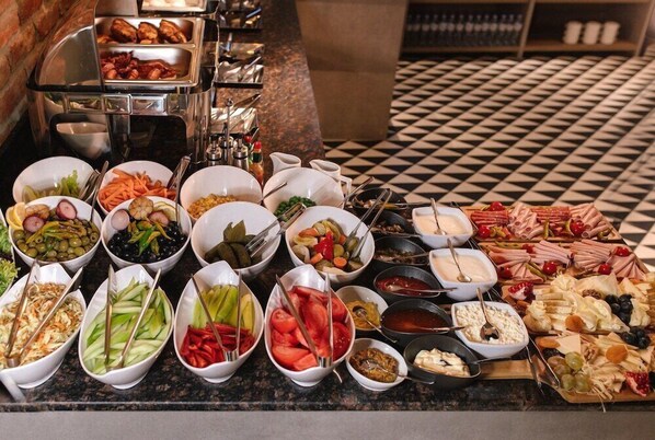 A buffet with various food items and utensils. - Hotel 21, Tbilisi (Tbilisi)