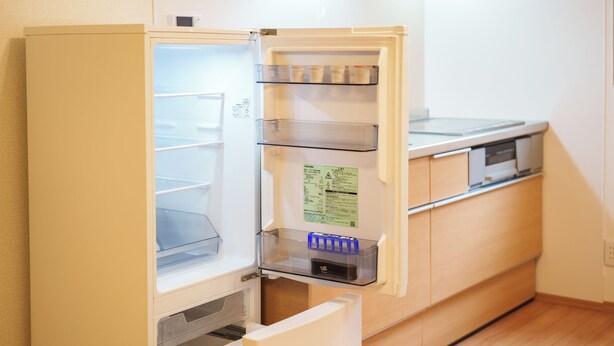 An open refrigerator with multiple shelves and a freezer compartment.
