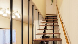 A staircase with wooden steps and black metal railings.