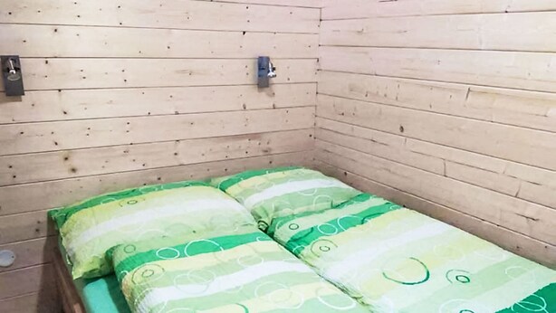 A small, single-bed room with wooden walls and a simple, clean design. - U Jelení obory by Interhome (Velke Karlovice)
