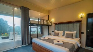 A bedroom with a large bed, a balcony with a view, and a wooden ceiling.