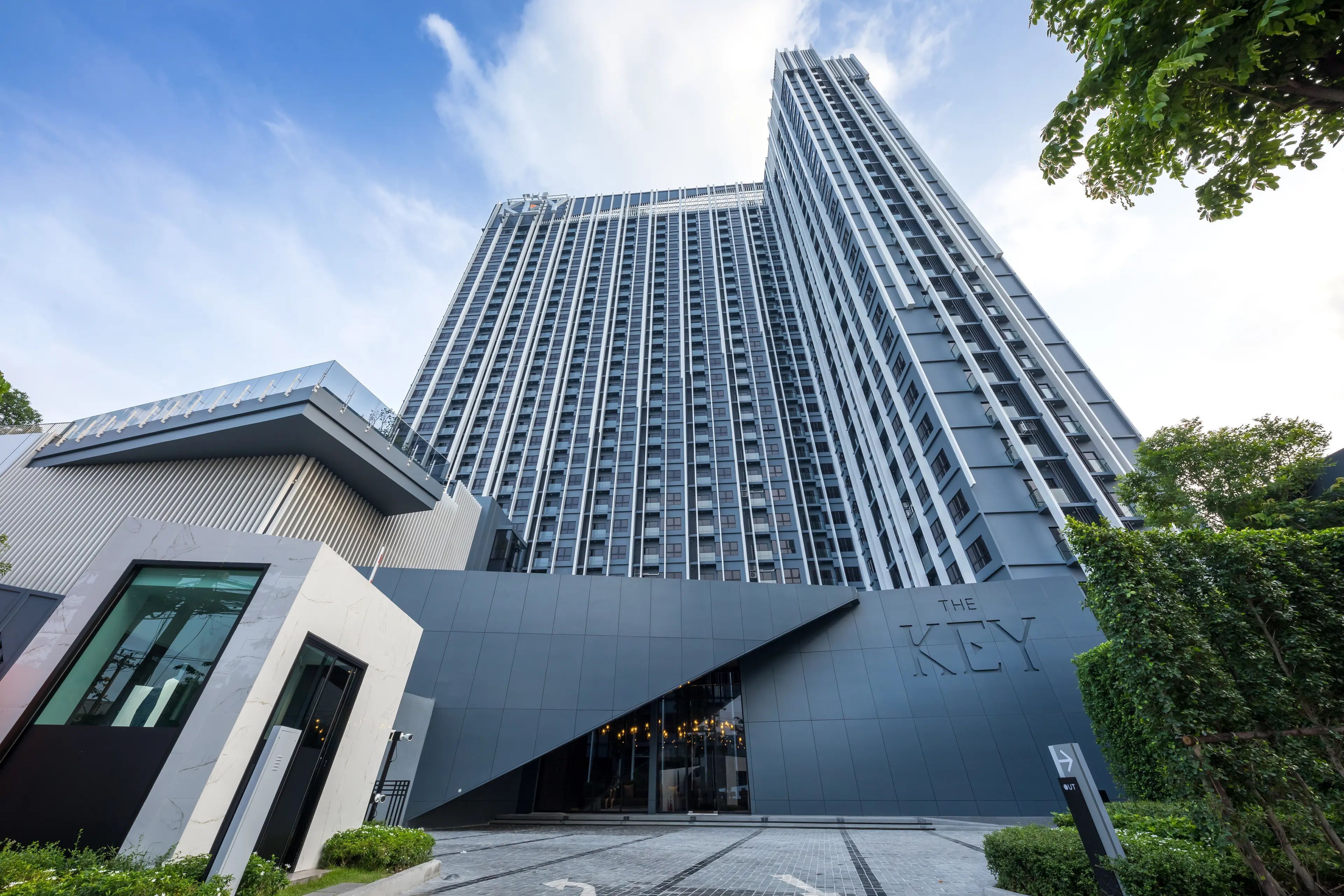 A modern building with a prominent entrance and a sign that reads 'THE KEY'.