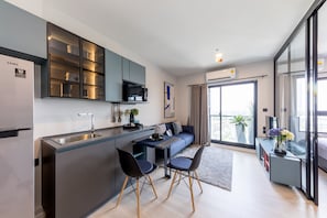 A modern kitchen with a built-in microwave, a stainless steel refrigerator, and a digital inverter. - Top-Floor Condo Next to MRT Blue Line, Near Malls, Pool, Gym & Quiet Living (Krung Thep Maha Nakhon)