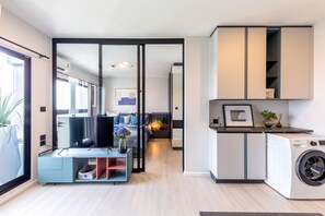 A modern apartment with a living area, a bedroom, and a kitchen. - Top-Floor Condo Next to MRT Blue Line, Near Malls, Pool, Gym & Quiet Living (Krung Thep Maha Nakhon)