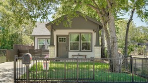A small house with a front porch, a mailbox, and a fenced yard. - Historic Southside Fort Worth Home w/ Fenced Yard! (Fort Worth)