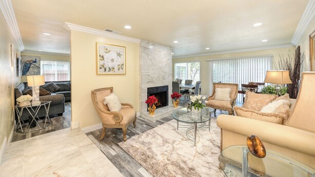 A spacious living room with a fireplace, a dining area, and a seating arrangement. - Near Golden 1 Center! Modern Home w/ Ping-Pong (Sacramento)