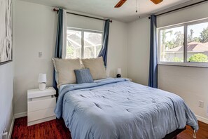 A bedroom with a bed, nightstands, a window with curtains, and a ceiling fan. - 2 Mi to Six Mile Preserve! Family Getaway w/ Pool (Fort Myers)