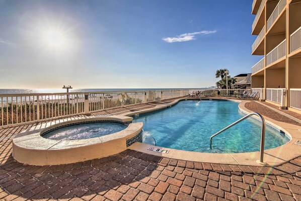 A swimming pool with a hot tub, a 3 FT depth marker, and a view of the ocean. - Gulf Views & Beach Access! 2 PCB Condos w/ Pool! (Panama City Beach)