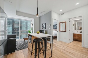A modern apartment with a kitchen, dining area, and a bedroom. - 1 Bedroom/1 Bathroom Suite (Montreal)