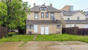 A two-story residential house with a front yard and a driveway.