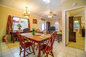 A dining room with a wooden table, chairs, and a ceiling fan. - 1 Mi to UAFS! Quiet & Cozy Apt w/ Fenced Yard (Fort Smith)
