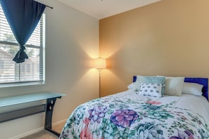 A bedroom with a bed, a bedside table, a lamp, and a window with curtains. - Relax Poolside, Explore South Mtn! Extended Escape (Phoenix)