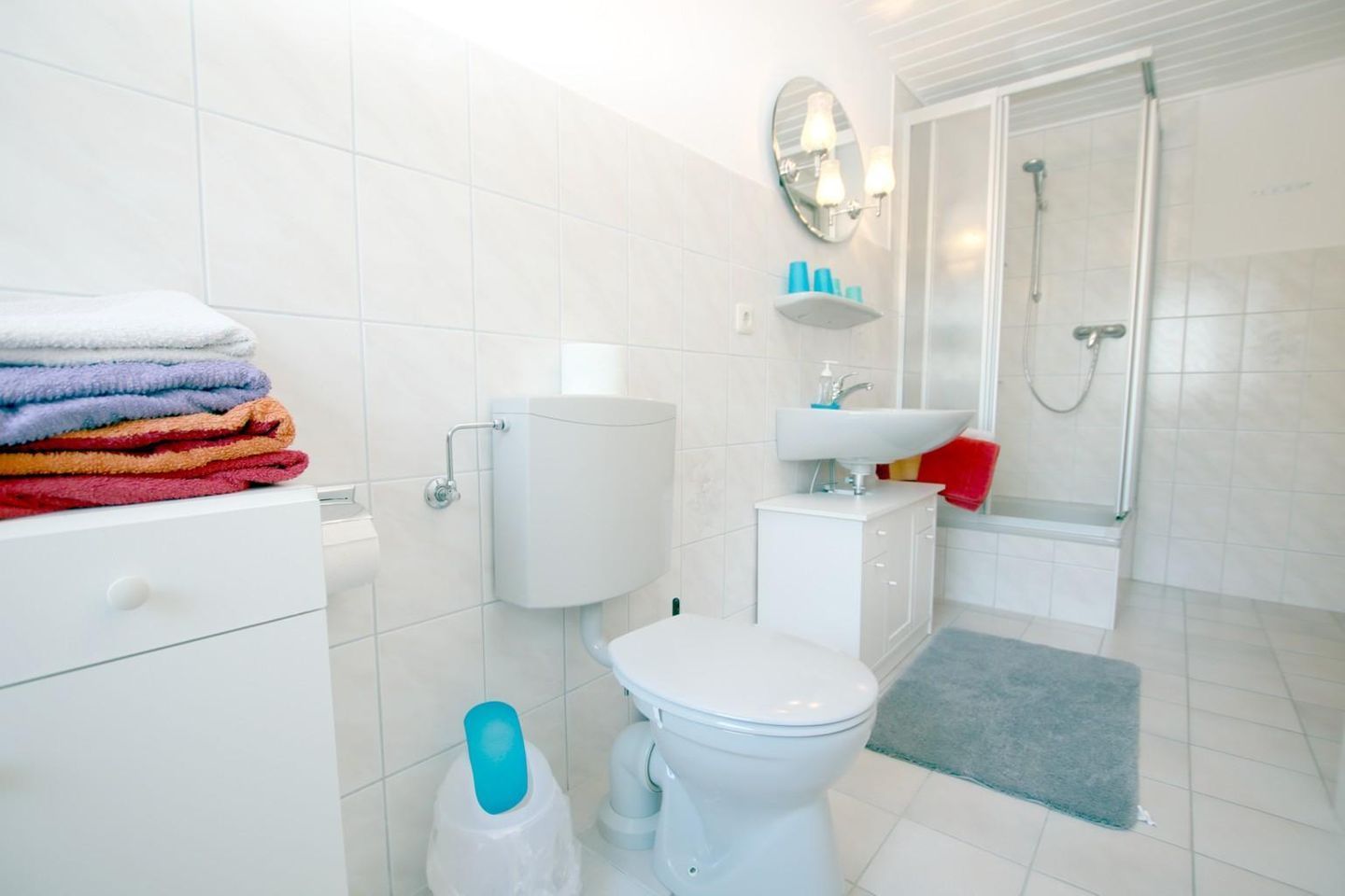 A modern bathroom with a toilet, sink, and shower.