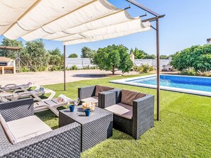 An outdoor patio area with a pool, lounge chairs, and a covered seating area. - Casa Rural Villa Manantial by Interhome (Sevilla/La Puebla de Cazalla)