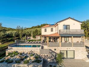 A two-story house with a swimming pool, stone walls, and a garden. - Dominika by Interhome (Motovun)