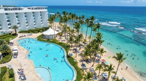 A resort with a large pool, beach, and ocean view. - Beachfront 6th Fl | Amazing View | Full Kitchen (Juan Dolio)