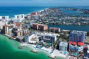 Eine Küstenstadt mit einem Yachthafen, Hotels und einem Strand.