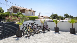 A rooftop with multiple bicycles parked and potted plants. - Apartment Dorota with private Pool near Fažana (Pula)