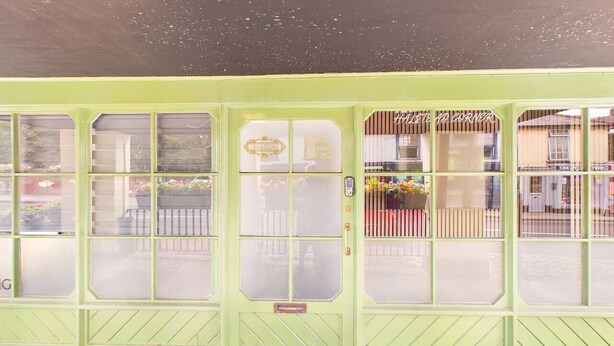 A green storefront with multiple glass windows and a sign that reads 'LET'S GO CORNER'. - High Street | Boutique 2 Bedroom | Wi-Fi (Essex)