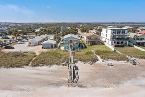 A coastal residential area with multiple houses, a beach, and a bridge in the background. - 7 bedrooms/4 bathrooms/sleeps 15 (St. Augustine)