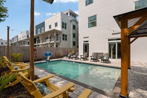 A residential pool area with lounge chairs and a basketball hoop. - Osprey Nest - Rooftop/Pool/Water Views (St. Augustine)