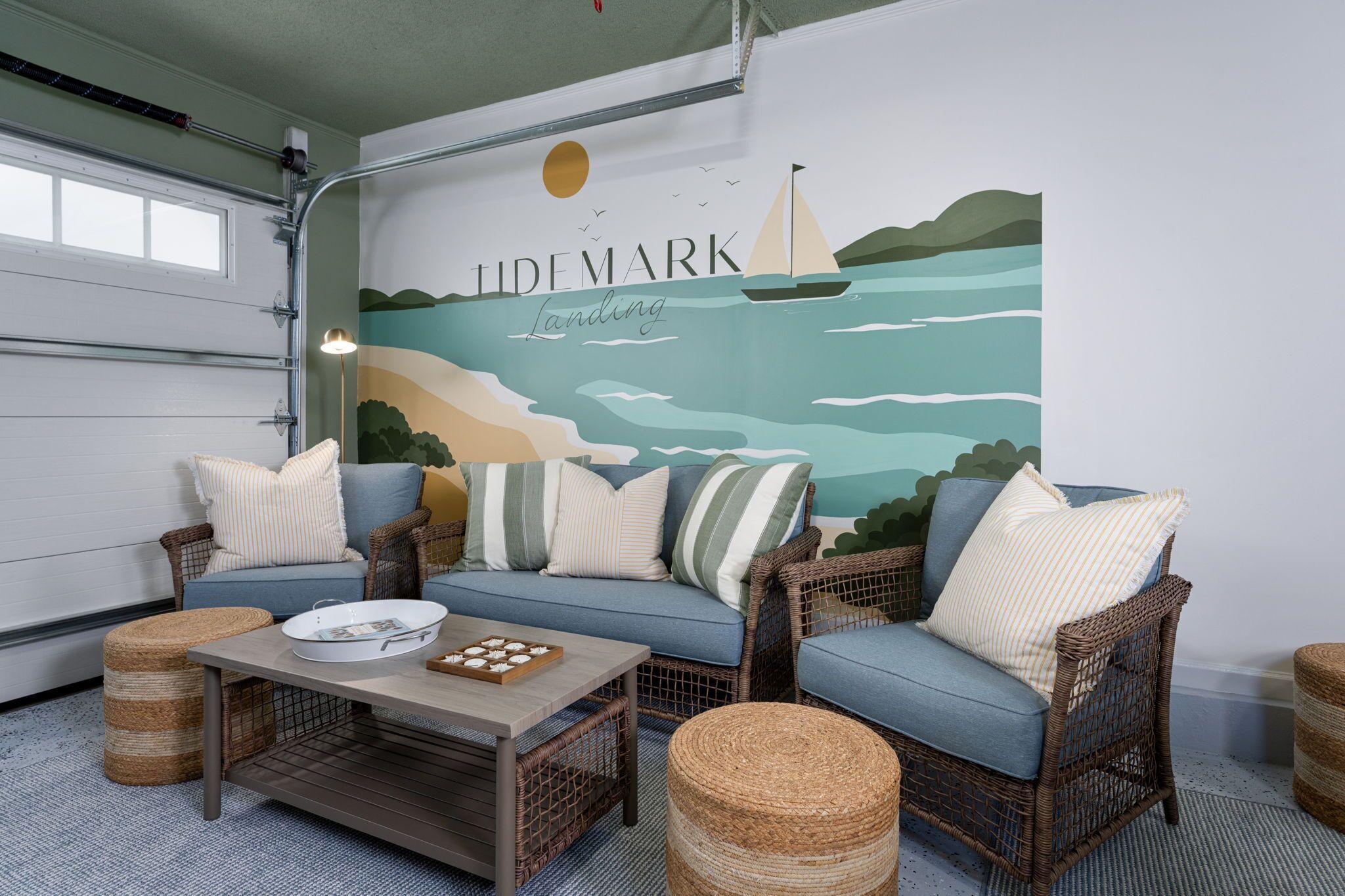 A room with a sofa set, wicker chairs, a coffee table, and a mural with the text 'LIDEMARK'.