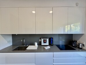 A modern kitchen with two sinks, a built-in oven, and a coffee maker. - Vilamoura Prestige 3 With Pool by Homing (Loulé)