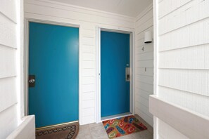 A hallway with two doors, one with a number '4' above it, and a colorful rug on the floor. - Modern Oceanfront Beach Club Villa *Unit 4* in Wild Dunes w/Community Pool! Screen Porch!! (Isle Of Palms)