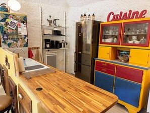 A kitchen with a wooden countertop, a refrigerator, and a colorful cabinet labeled 'Cuisine'. - Unique troglodyte cave - 4 guests (Nazelles-Négron)