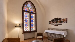 A room with a large stained glass window, a fireplace, and a table with chairs. - House with pool and AC - 12 guests (CHANDON)