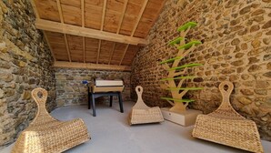 A rustic room with stone walls, a wooden ceiling, and a stone bench. - House with pool and AC - 12 guests (CHANDON)