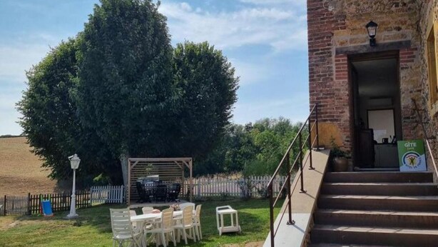 A brick building with a staircase leading to a covered outdoor area with a table and chairs. - House with pool and AC - 12 guests (CHANDON)