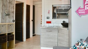 A modern kitchen with a built-in oven, a sink, and a window above the counter. There is a sign on the wall that reads 'HAPPY HOURS'. - Apartment in the heart of Avoriaz - 4 guests (Avoriaz)