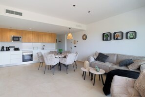 A modern living space with a kitchen, dining area, and seating area. - La Casa Alegría, a luxury 3-bedroom apartment (San Javier)