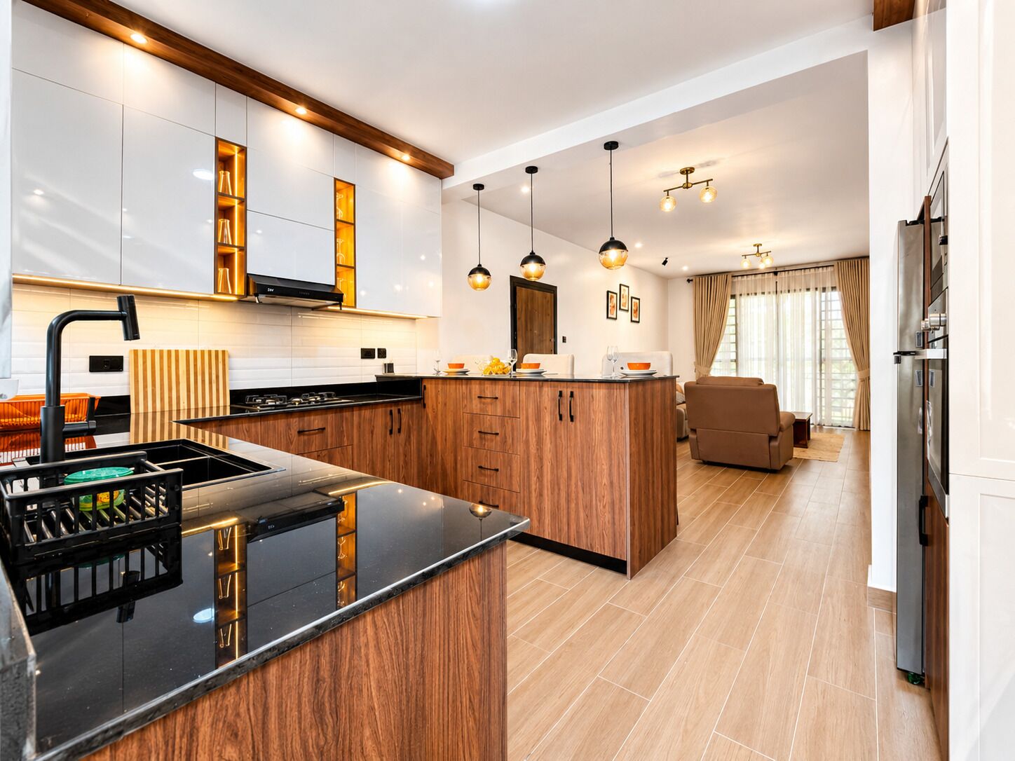 A modern kitchen with a central island, wooden cabinets, and pendant lighting.