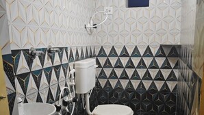 A bathroom with a toilet, sink, and shower. - Gorgeous 6-bedroom house with AC in charming Sanapur (Sanapur)