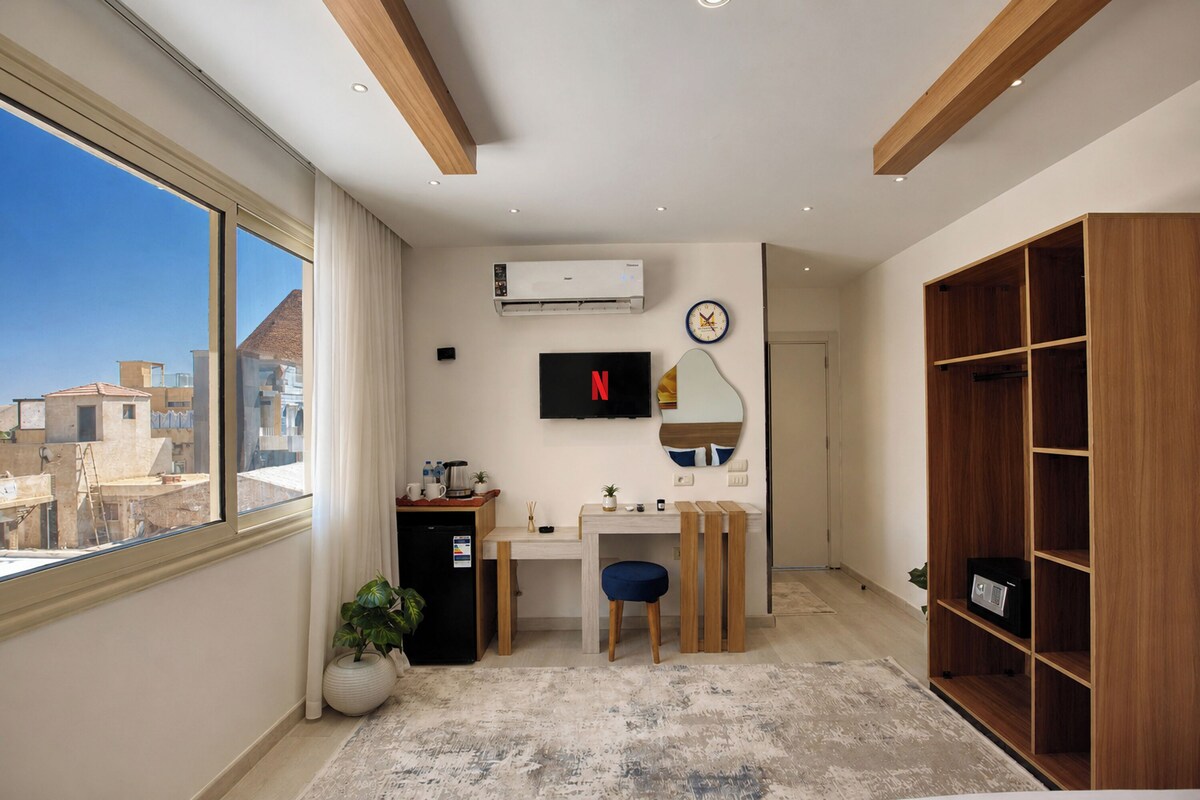 A modern room with a desk, chair, and a large wardrobe.