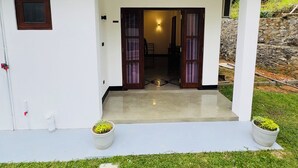 A modern house with a white exterior, a covered porch, and a stone wall. - Private 2 Bedroom Villa with 2 King Beds Near Unawatuna Beach (Unawatuna)