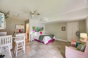 A bedroom with a bed, a desk, a chair, a ceiling fan, and a door. - Lanai, Pool Access! Naples Studio Near Beach (Naples)