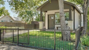 A single-story house with a front porch, a fenced yard, and a tree in front. - Historic Southside Fort Worth Home w/ Fenced Yard! (Fort Worth)