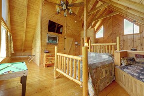 A wooden cabin interior with a bed, a television, a billiards table, and a window. - 1 Mi to Dollywood! Hot Tub Hideaway in Smokies (Sevierville)