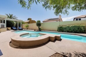 A swimming pool with a hot tub, surrounded by a patio area with lounge chairs. - Poolside Chills, Casino Thrills! Las Vegas Getaway (Las Vegas)