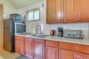 A kitchen with wooden cabinets, a stainless steel refrigerator, a gas stove, a sink, a window, and a toaster. - 2-unit Combo, 6 Mi to Bethel Woods Center! (Mongaup Valley)