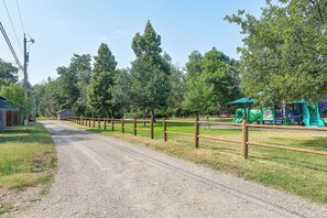 A gravel path leading to a playground with a slide and climbing structures. - Walk to Park & Creek! Spearfish Couples Retreat (Spearfish)