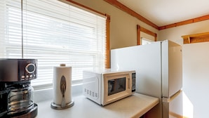 A kitchen with a coffee maker, paper towel holder, and a microwave on the counter. - Walk to Park & Creek! Spearfish Couples Retreat (Spearfish)