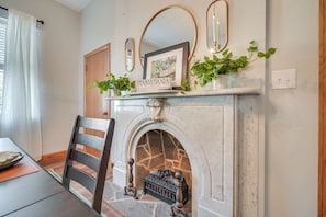 A fireplace with a sign reading "Pennsylvania," a framed picture above it, and a potted plant on the mantel. - 2-apartment Combo in Dtwn Bedford: Hike & Golf! (Bedford)
